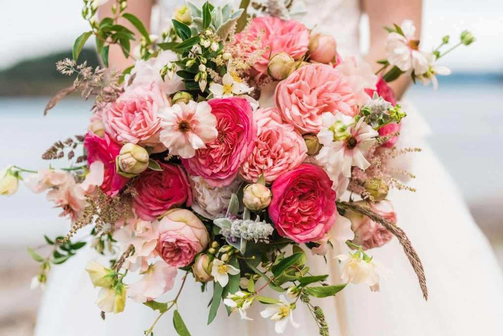 Pink garden rose wedding bouquet with white blooms and greenery