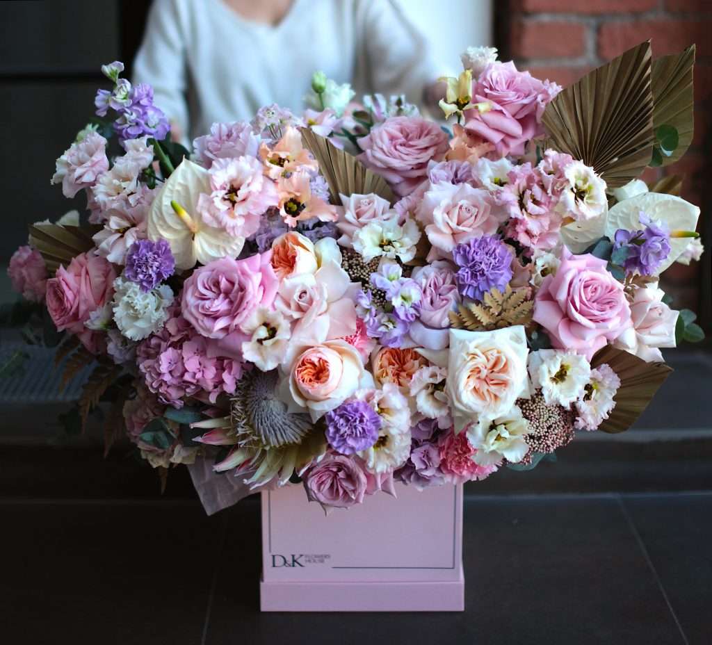 Lavender and pink garden rose box arrangement with dried palm accents