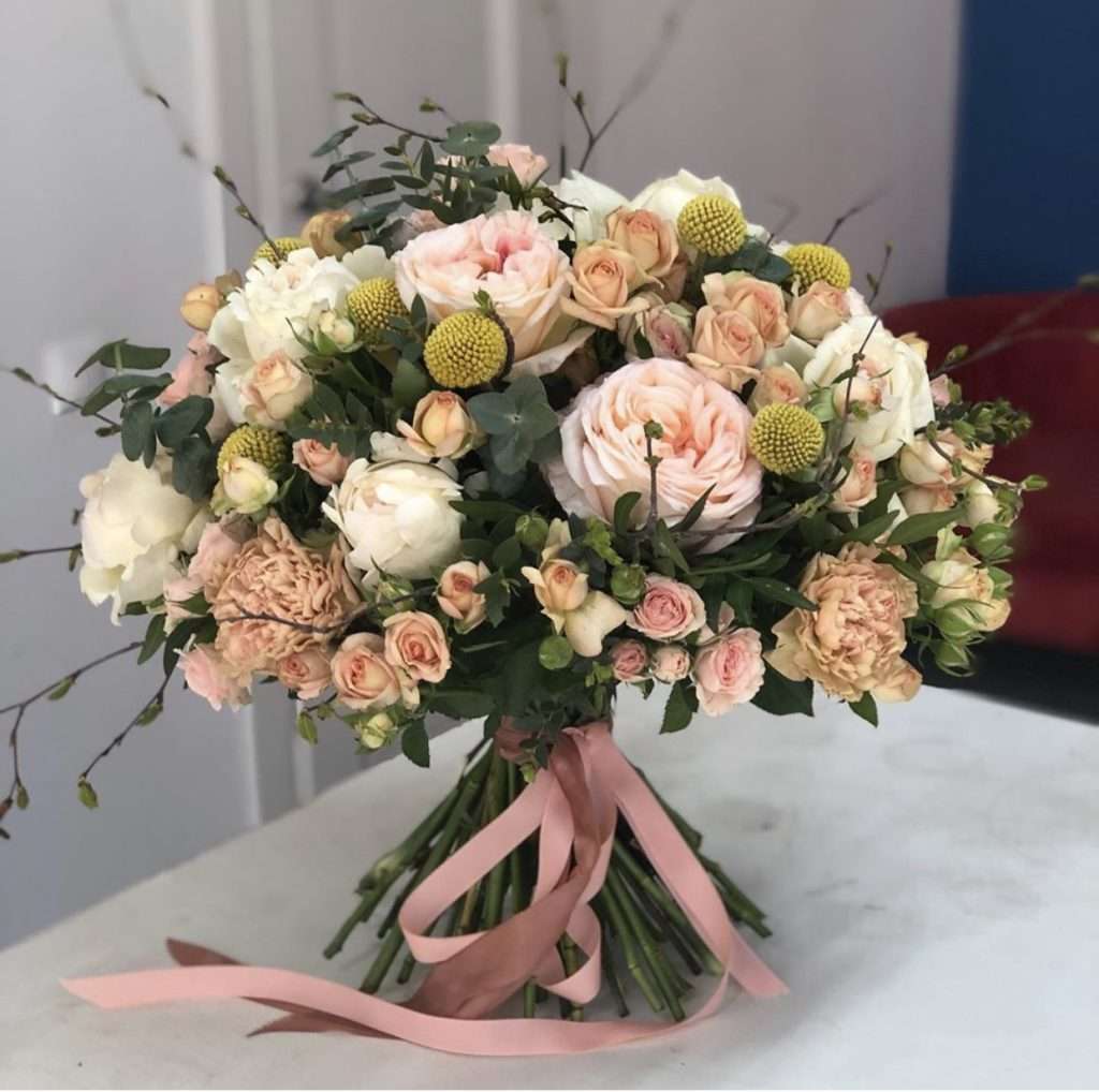 Ivory and blush garden rose bouquet tied with pink ribbon
