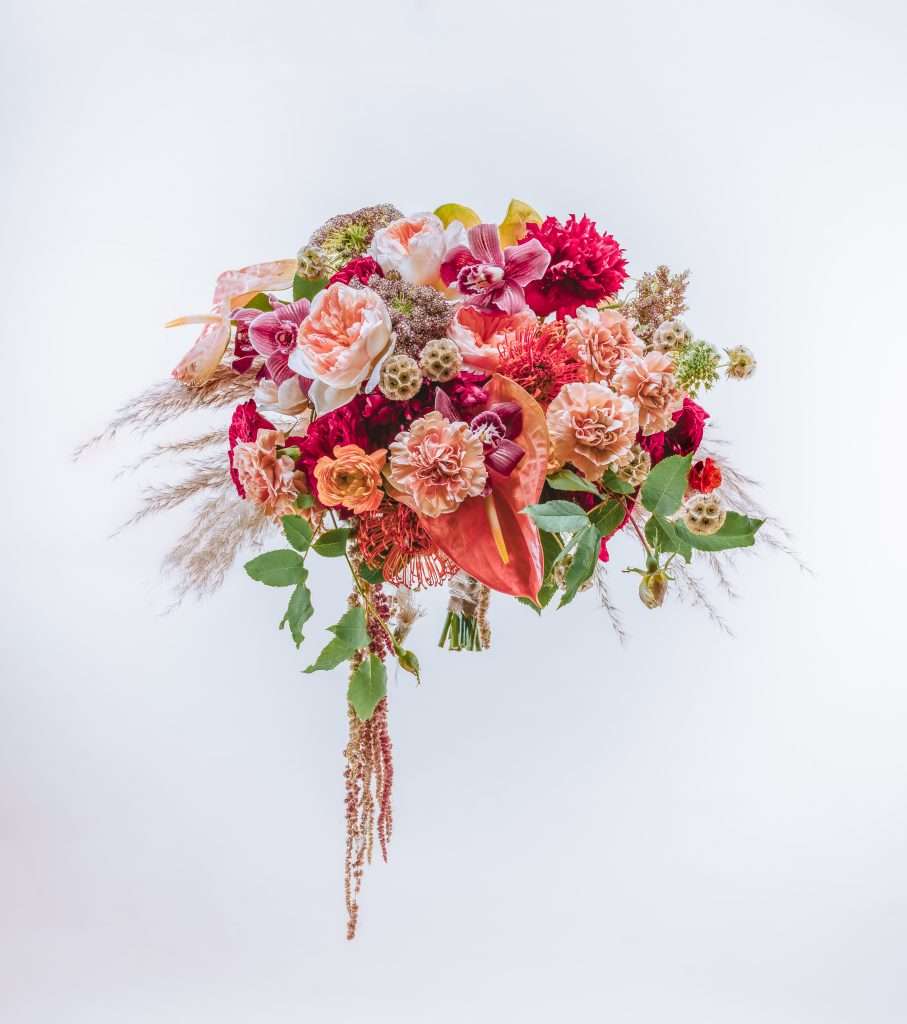 Autumn-toned bouquet with garden roses, carnations, orchids and pampas grass