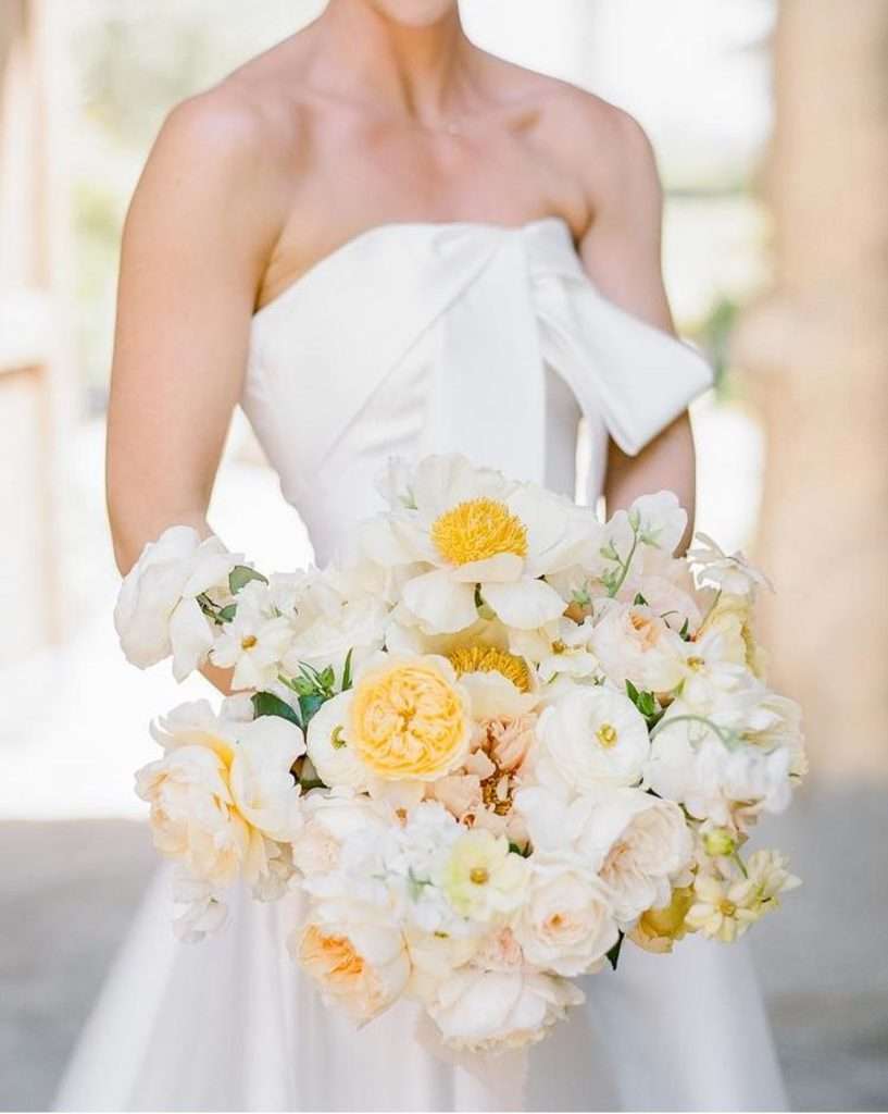 Bride holding a butter yellow and white David Austin garden rose bouquet