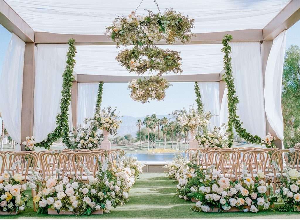 Wide view of the draped pavilion and floral installations before guests arrive