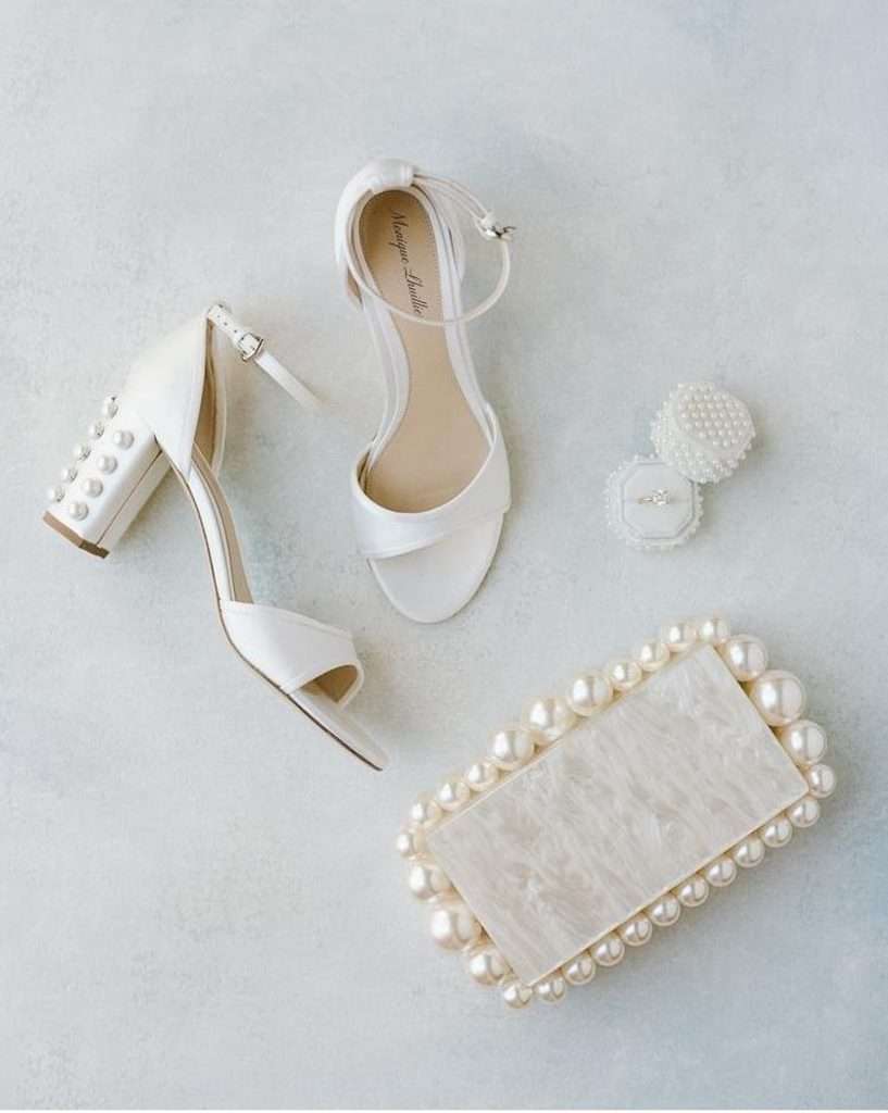 Bridal shoes and pearl-beaded clutch styled on a flat lay