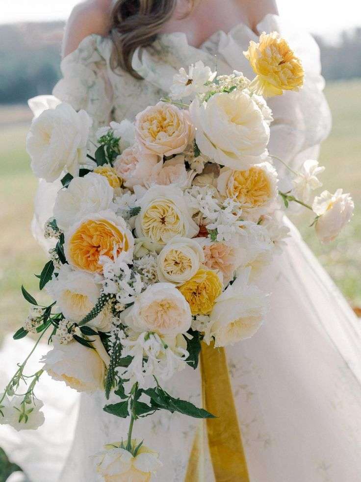 Close-up bridal bouquet mixing cream and buttery yellow David Austin garden roses