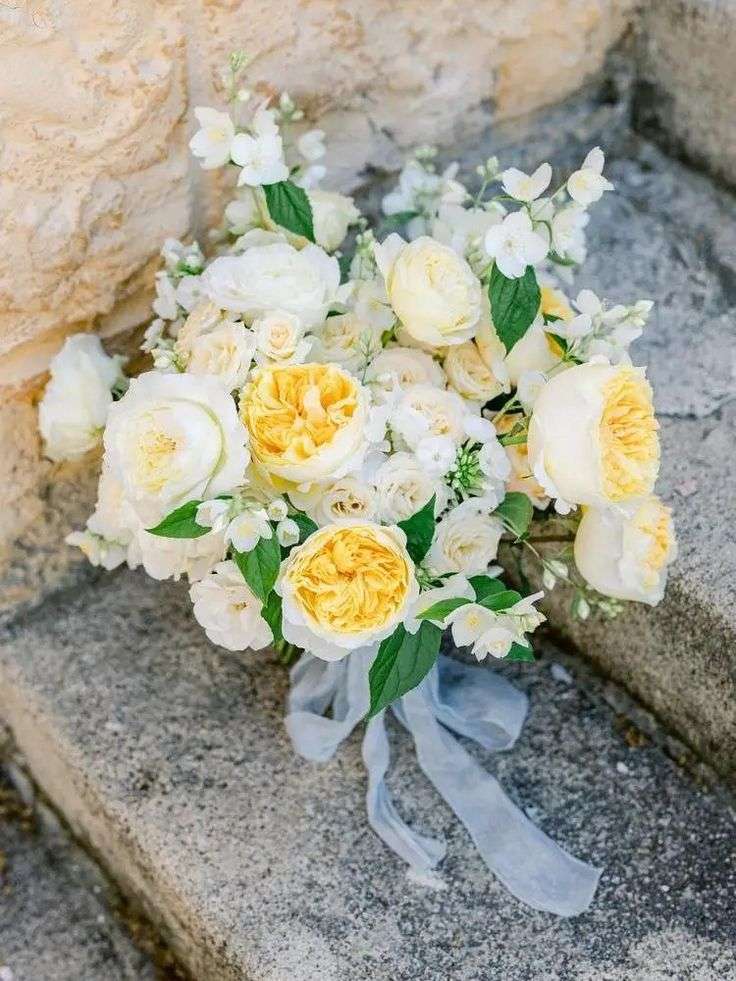 Sunshine-hued bridal bouquet with Effie and Patience garden roses on stone steps