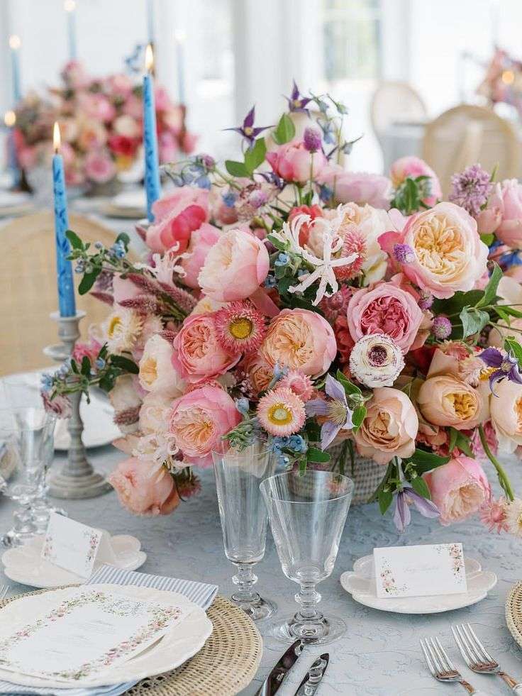 Pink garden rose centerpiece with blue taper candles and place cards