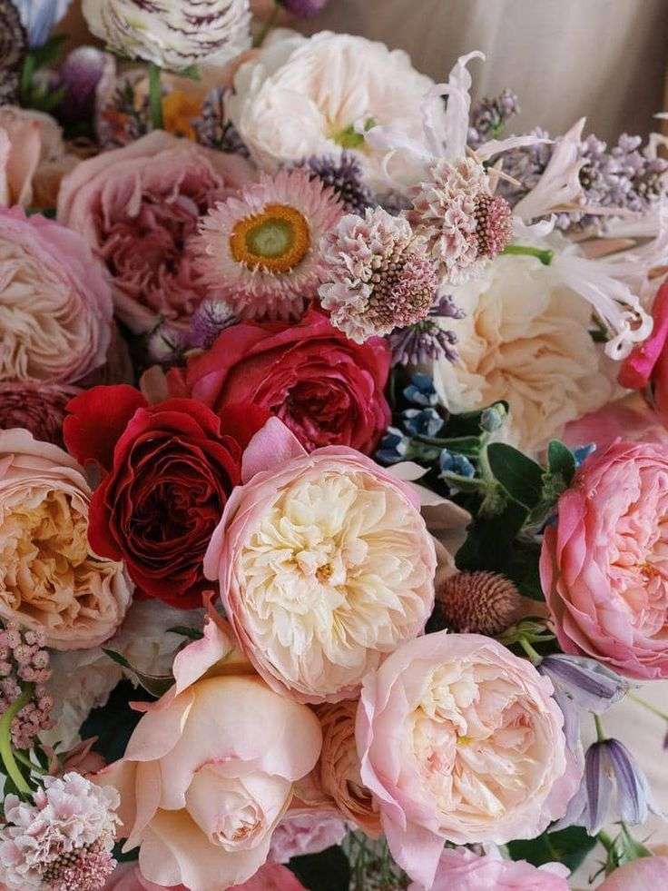 Close-up of blush and red garden roses mixed with lavender and dried florals