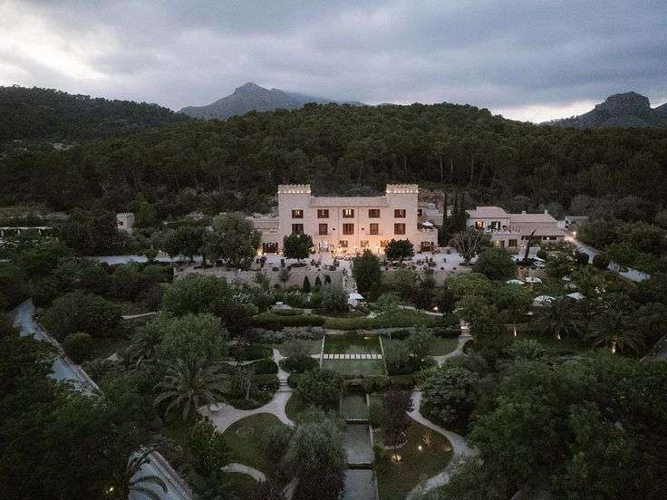 Aerial view of Castell Son Claret castle and gardens at dusk in Mallorca