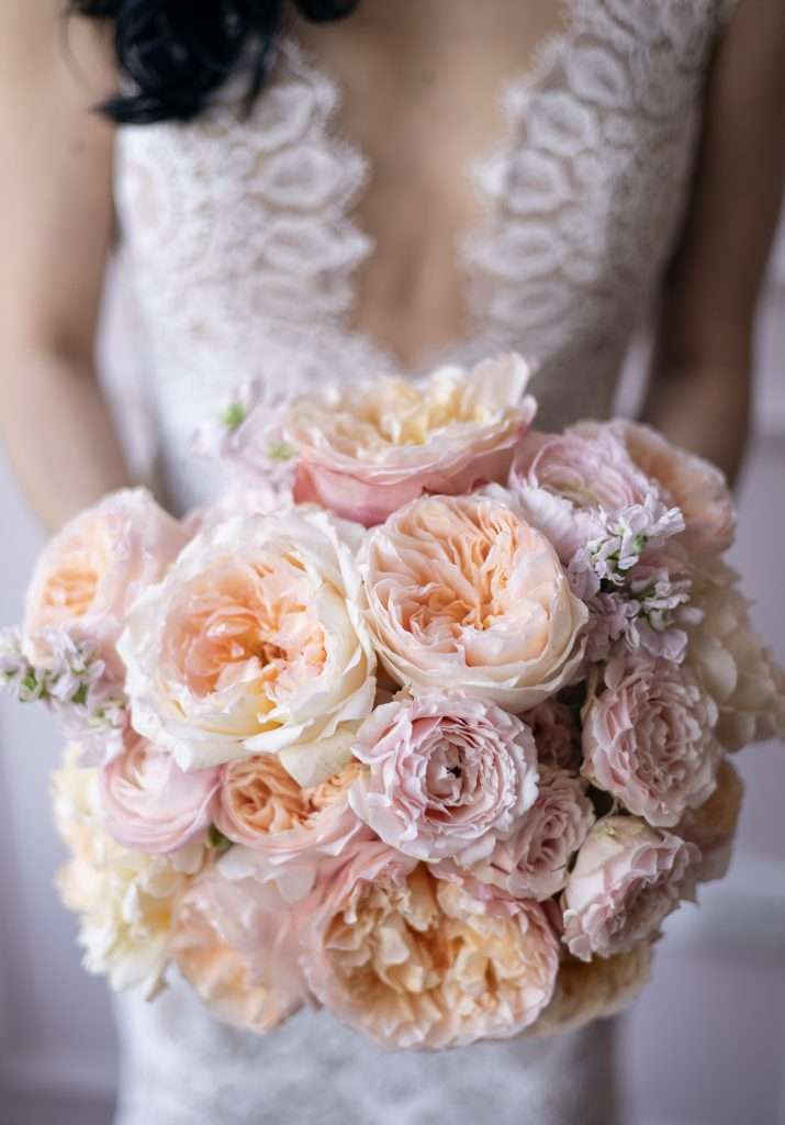 Close-up of a peach and blush garden rose bridal bouquet