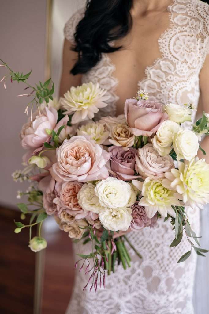 Mauve and cream garden rose bouquet with dahlias and trailing greenery