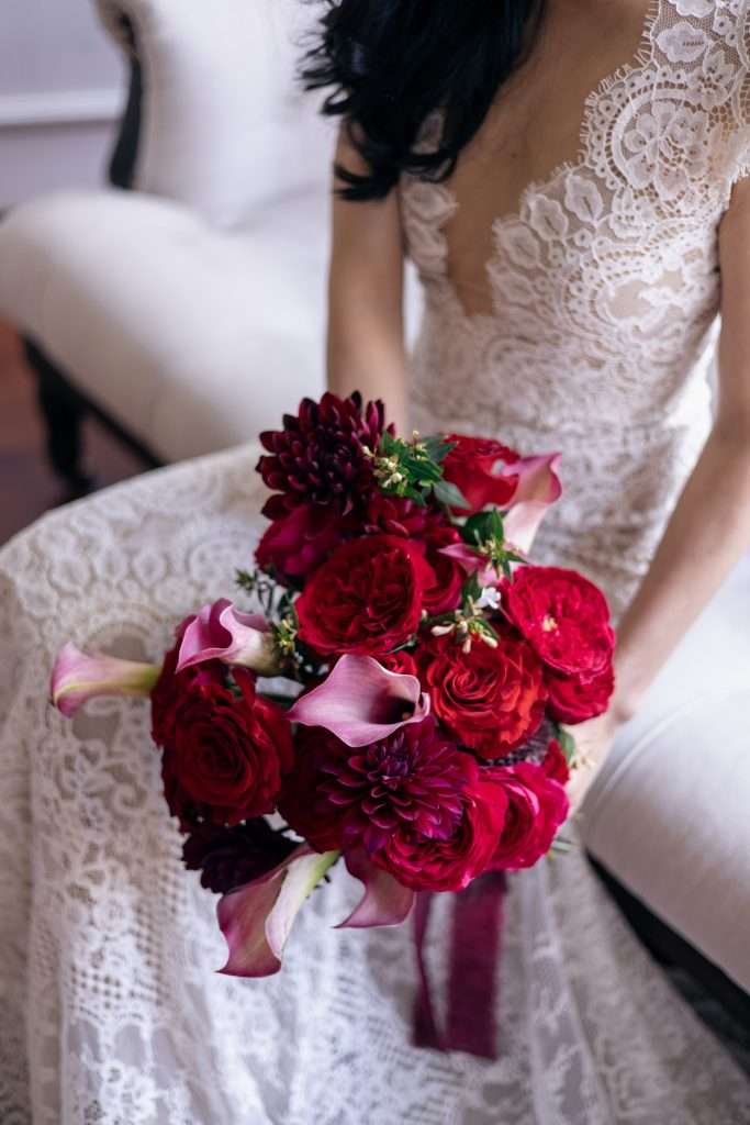 Overhead view of a red garden rose bouquet with calla lilies and dahlias