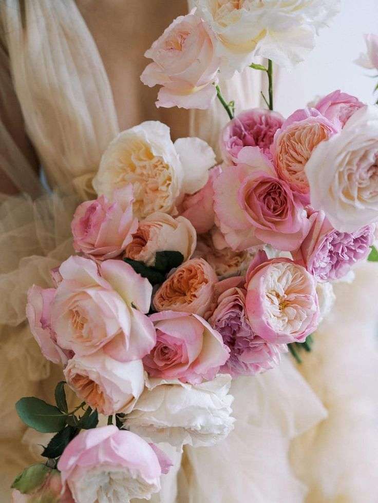 Blush and mauve garden roses arranged in a soft romantic bridal bouquet